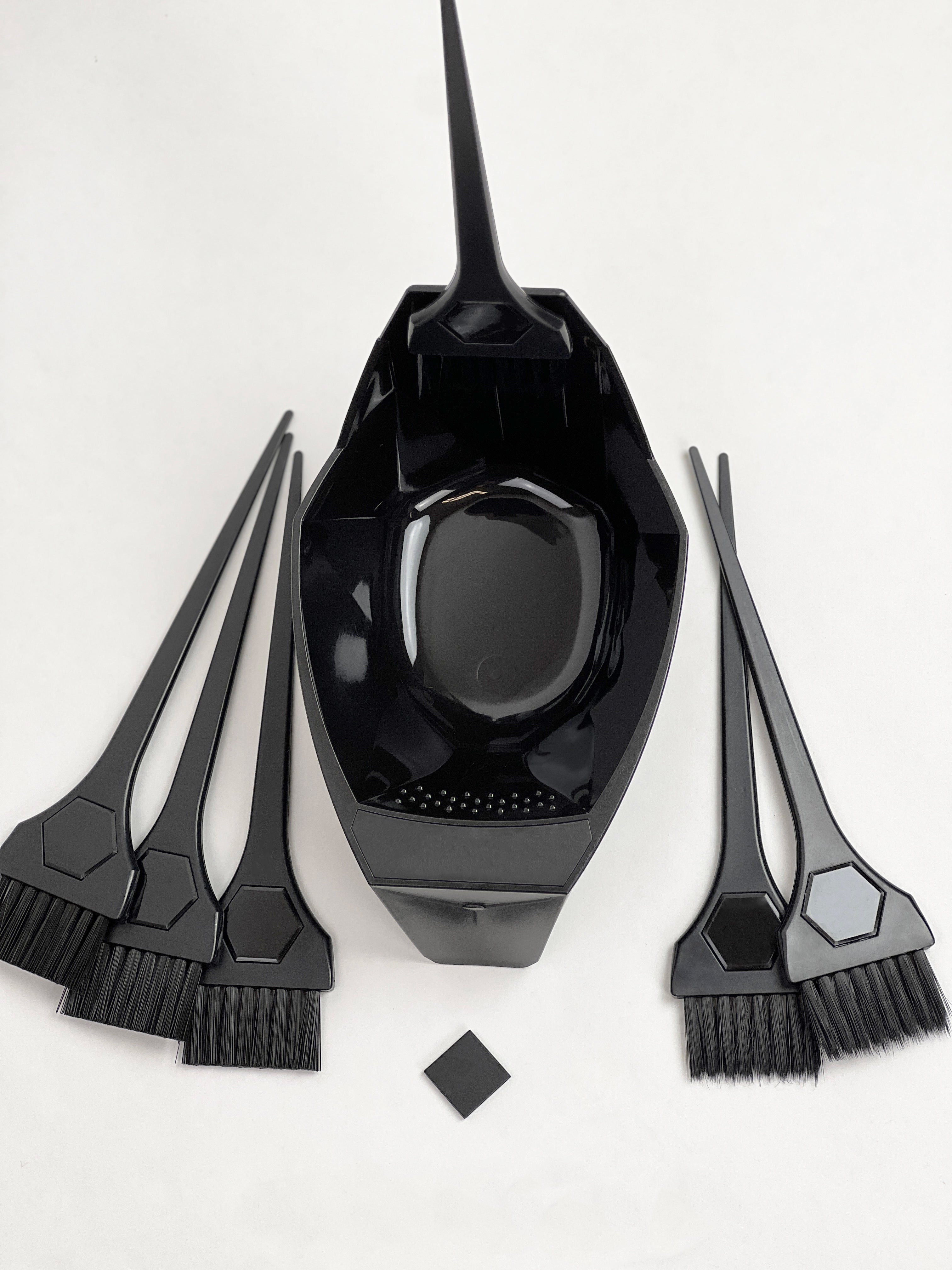 Black magnetic  hair dye mixing bowl with brushes on a white background