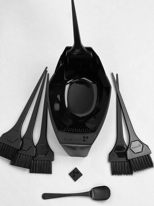 Magnetic Black hair dyeing tools including a bowl, brushes, and a spatula on a white background.