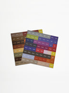 Set of colorful hair color formula label sheets for Redken Shades EQ bottle caps on a white background